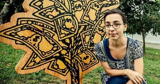 Potrait of Anne Percoco with her artwork (a tree sculpture installed outdoors)